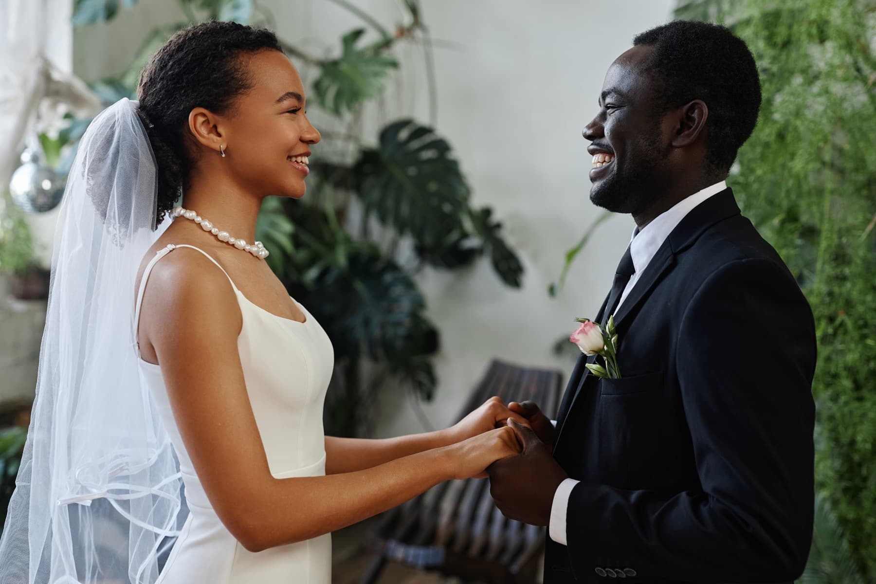 Bride and groom smiling together in a wedding scene.