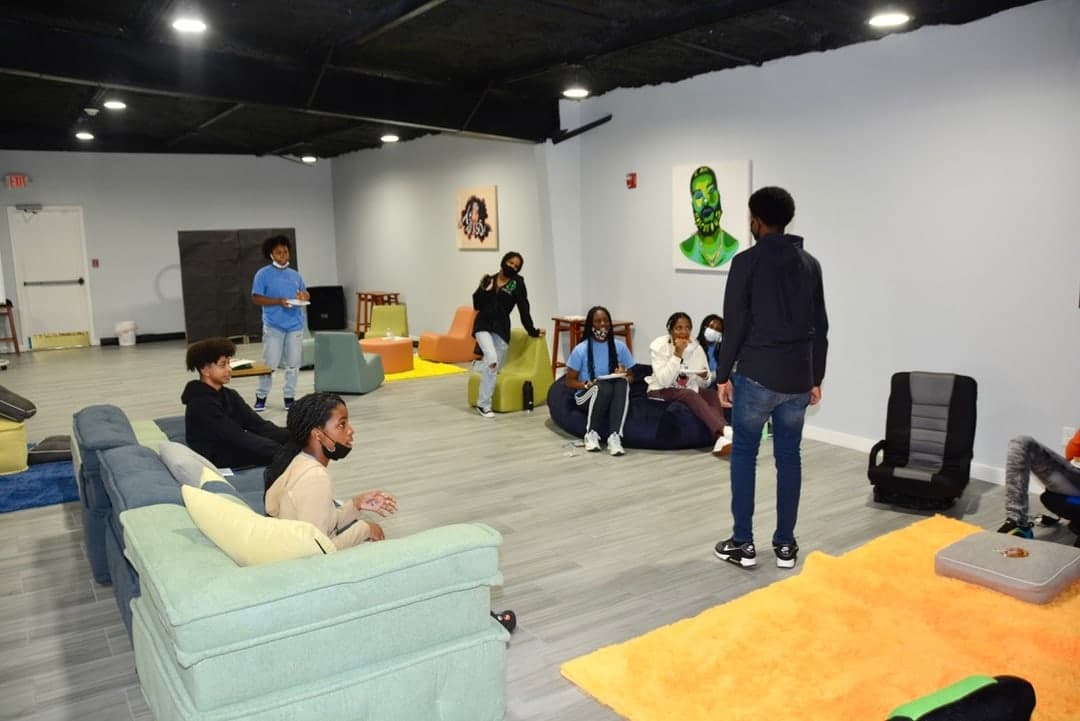RGD youth gathered in a lounge setting for leadership discussion.