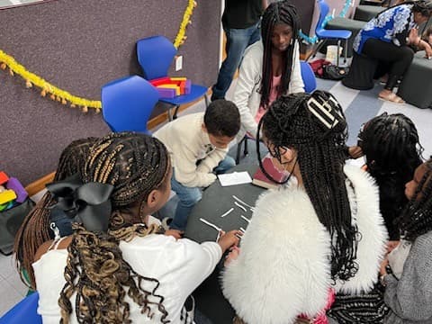 Youth students working together on an activity in class.