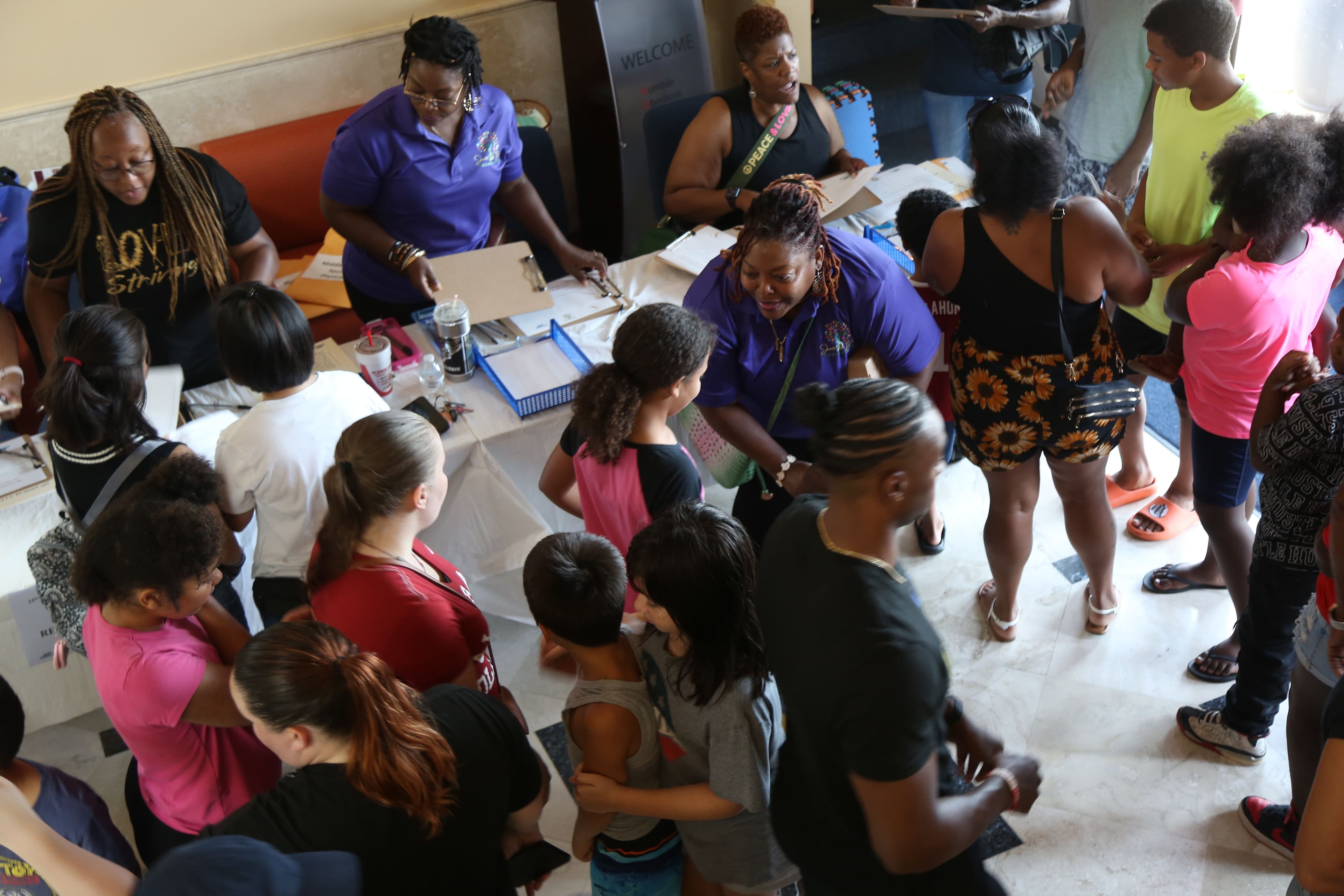 Families and students connecting during youth registration.